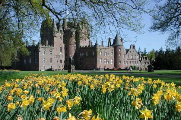 Glamis Castle in Scotland with daffodils