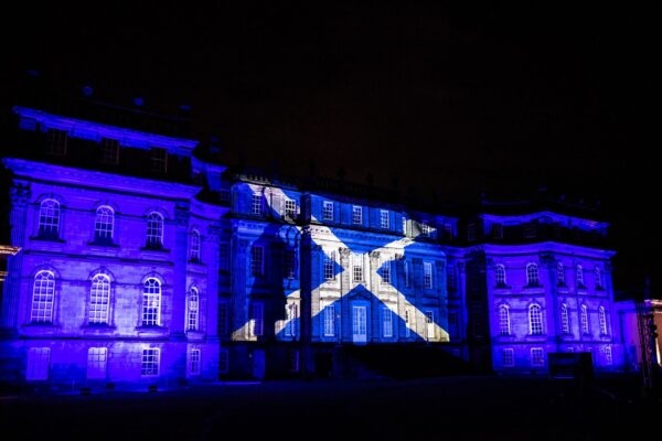 Hopetoun House in Scotland projects the Scottish flag on the walls