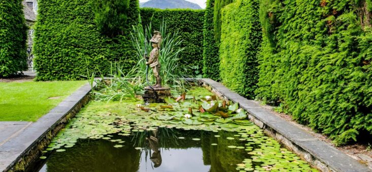 Plas Brondanw pond with statue