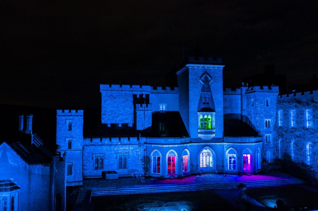 Powderham Blue lights across the castle walls