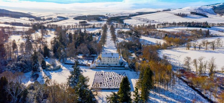 Snow on Traquair House and maze in Scotland