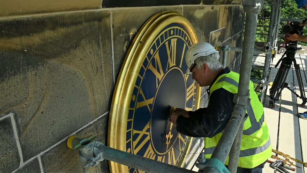 Wentworth Andrew Bates fitting the restored clock hands