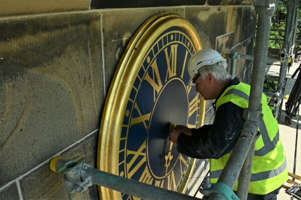 Wentworth Andrew Bates fitting the restored clock hands