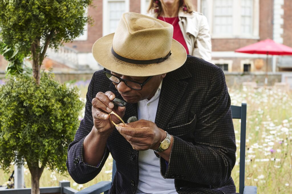 Ronnie Archer-Morgan examines an object at Ham House in London.