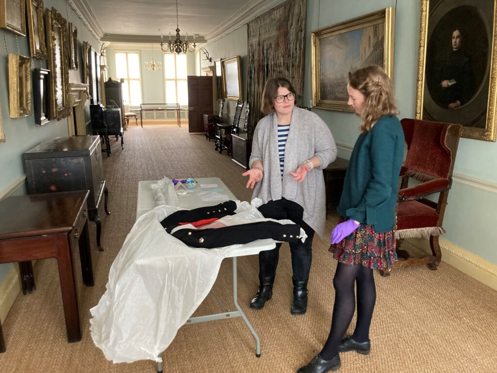 Curator Alice Rose and student Imogen Hayden working with collections in the accredited museum and historic house[40]